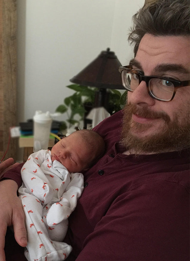 Father holding baby after IVF treatment birth